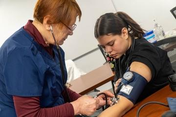 Student takes another student's blood pressure